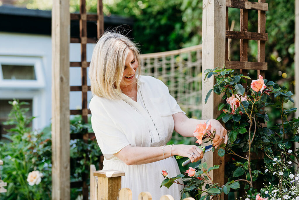 How Flower Power can help heal - Fiona tending to flowers in flower garden