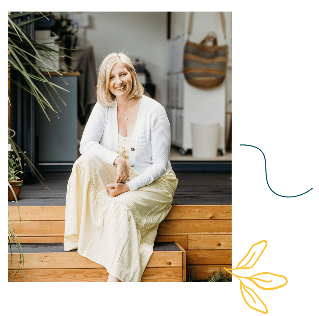 Fiona Stimson - Health Empowerment Coach and Integrative Clinical Hypnotherapist - sitting on steps earing a white tops and yellow dress.